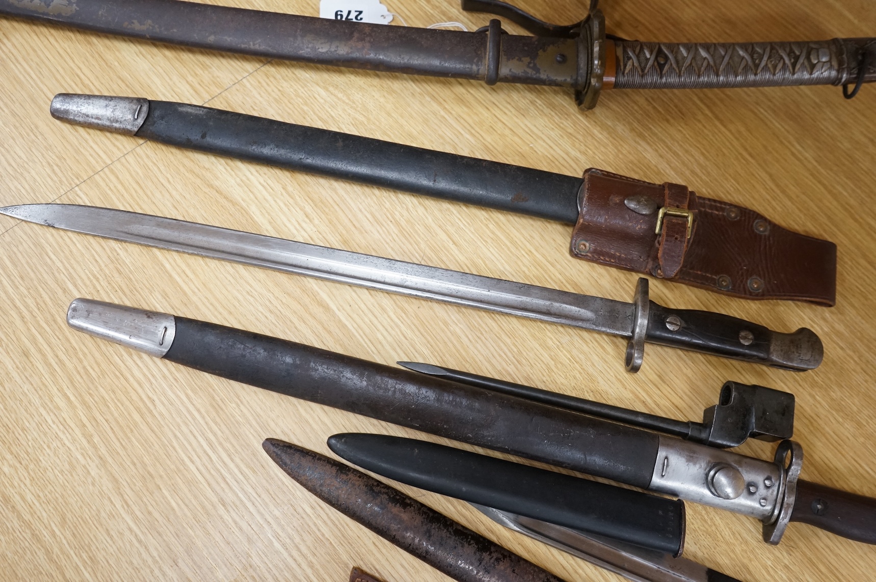 A 1907 bayonet by Wilkinson in its steel mounted leather scabbard, another similar with leather frog, two small British bayonets, a Continental bayonet, and two assorted hunting knives (7)
